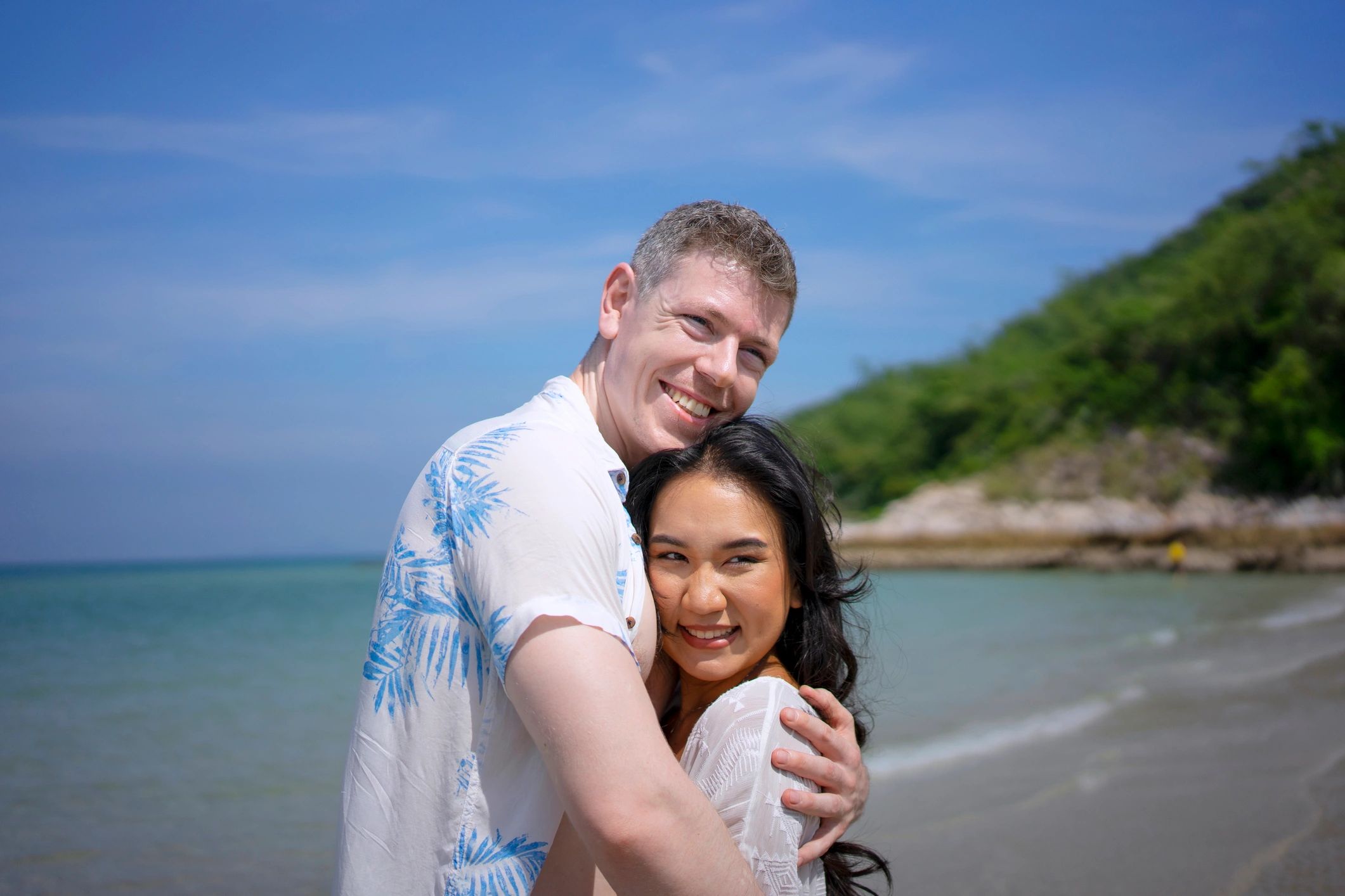 Romantic couple portrait by the beach