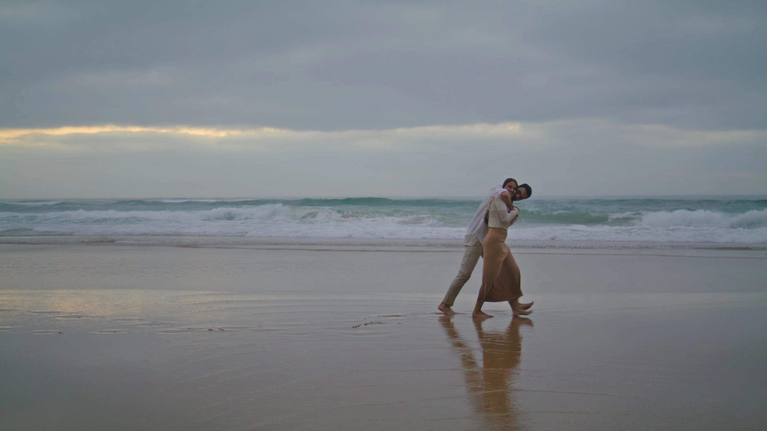 Couple walking along the shoreline