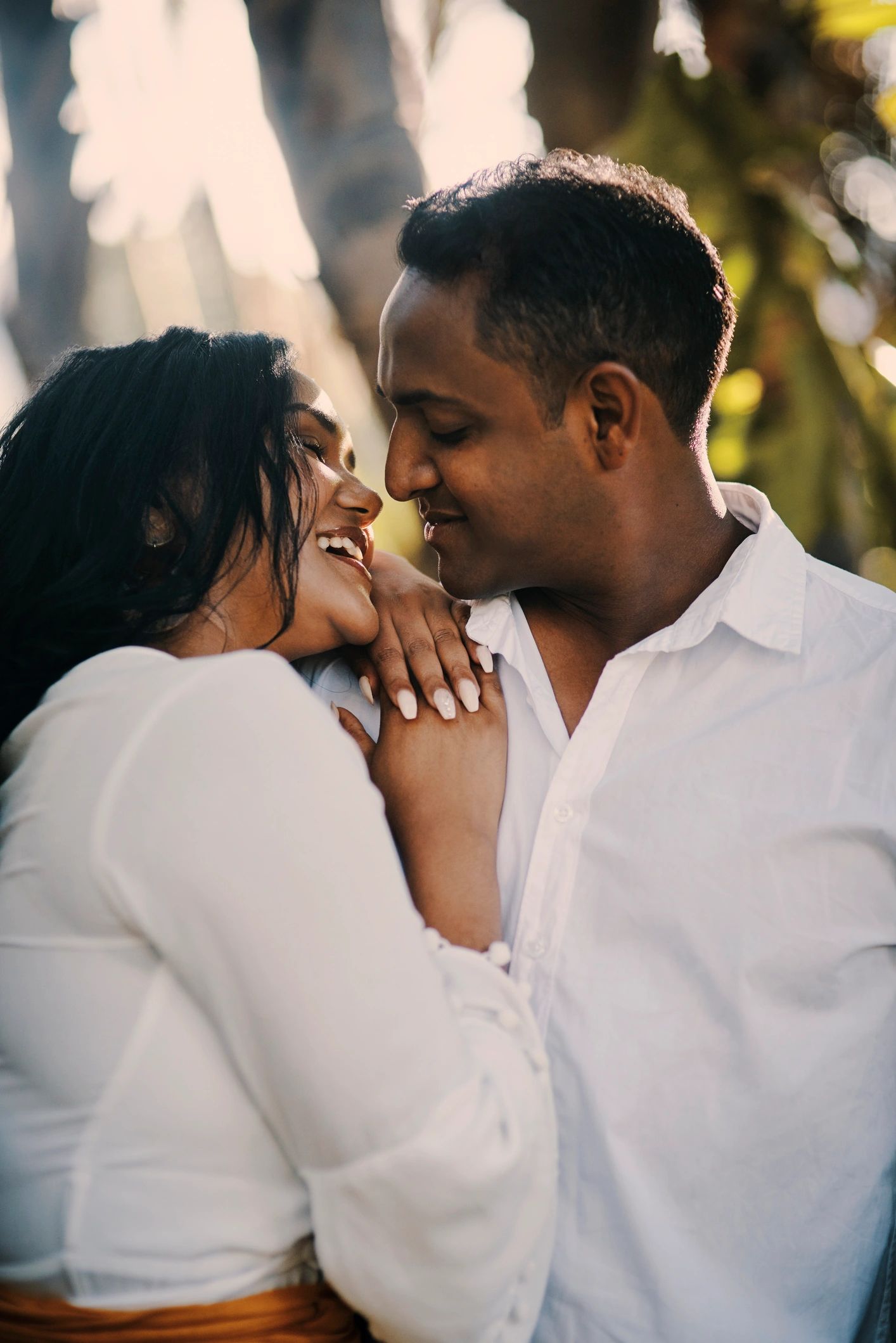 Romantic engagement portrait of a smiling couple