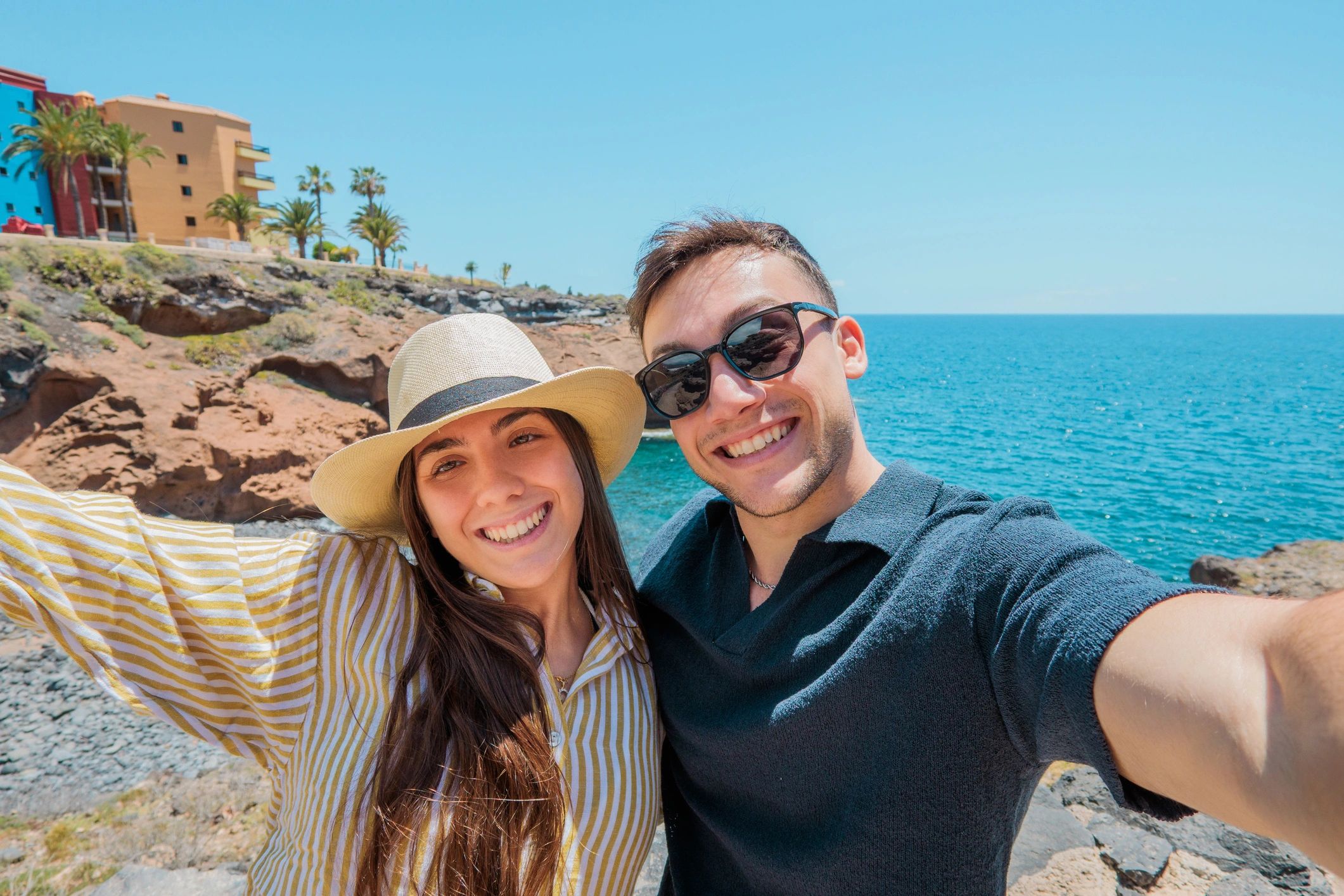 Couple taking a seaside selfie on vacation